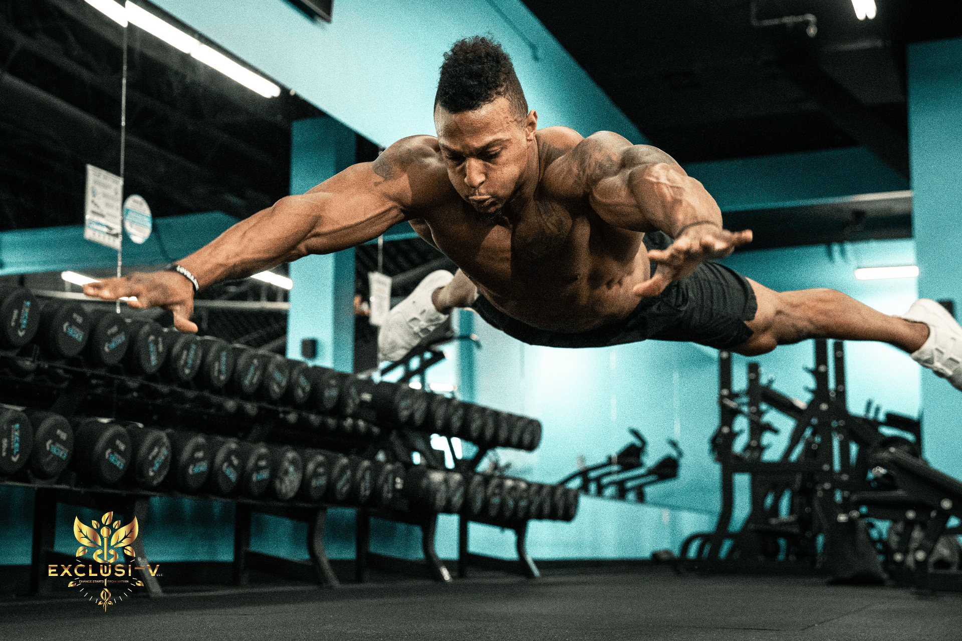 Muscular athlete doing workout in gym